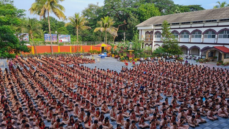 Large school assembly in the campus courtyard