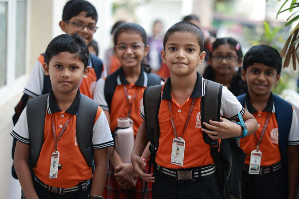 Students posing together with backpacks on campus
